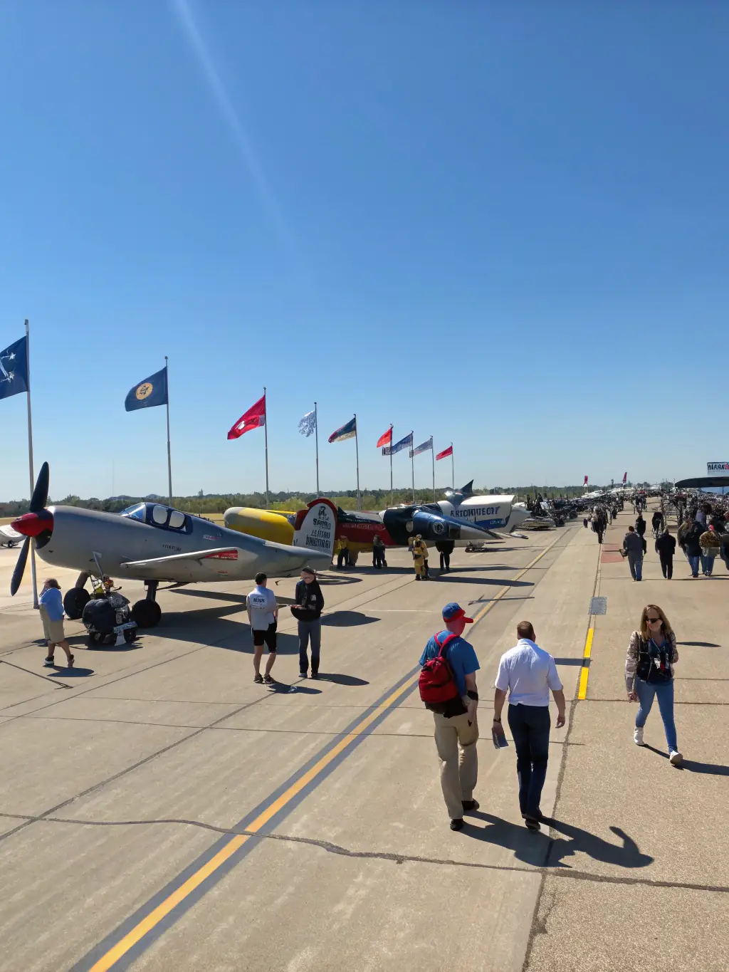 A diverse group of participants, including adults and children, attending an aviation-themed event organized by GSAA, emphasizing community engagement.
